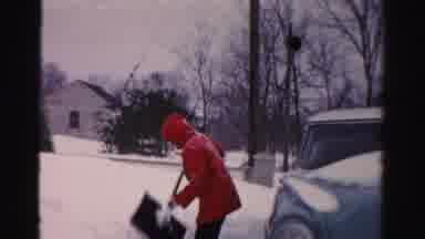 Albany New York (1955): A Person Wearing A Red Jacket With Their Hood Up Is