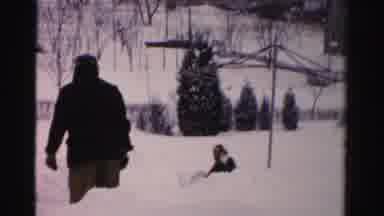 Albany New York (1955): A Man Helping A Person Who Is Stuck In The Snow The Ground