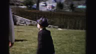 Albany New York (1955): Woman Wearing White Coat Runs With Boy Wearing Brown Coat