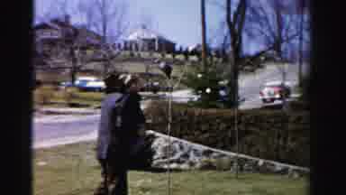 Albany New York (1955): Person Wearing Black Jacket Carries Small Child On A