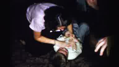 Albany New York (1955): Older Girl And Younger Boy Play Wrestle Inside A House