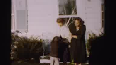 Albany New York (1955): Child Wearing Brown Coat Chases Woman Wearing White Coat