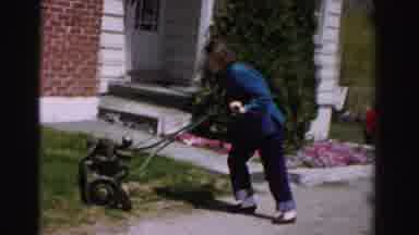 Albany New York (1955): An Old Gas Push Mower Being Pushed By A Woman Who Is