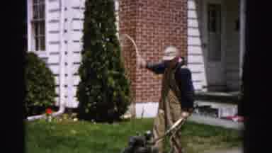Albany New York (1955): A Man Attempts To Start His Mower And Revs Out The Cord