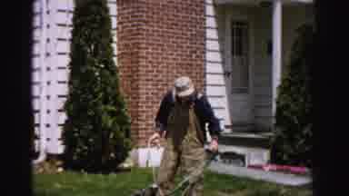 Albany New York (1955): A Man Sitting Down Near Garage Working On Lawn Mower
