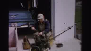 Albany New York (1955): Man Wearing Coveralls And Ball Cap Servicing Lawn Mower In