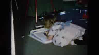 Hicksville New York (1956): Girl Wearing Pink Dress Looks At White Object On Floor