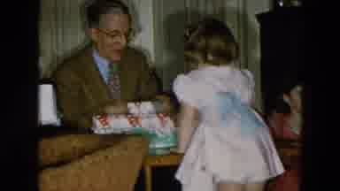Hicksville New York (1956): Girl Wearing Pink Dress Opens Christmas Gift Box On