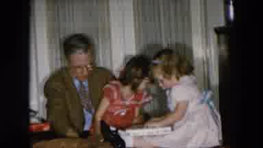 HICKSVILLE NEW YORK-1956: Father and Daughters Open Wrapped Presents