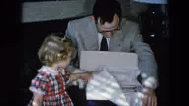Hicksville New York (1956): Father In A Well Dressed Suit Opening A Pair Of
