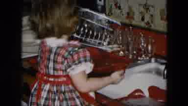 Hicksville New York (1956): Girl Plays In A Sink Under The Supervision Of An Adult
