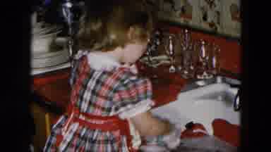 Hicksville New York (1956): A Young Child Washing Dishes In The Kitchen Sink While
