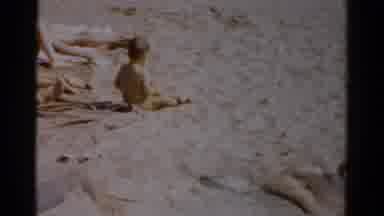 Catskill New York (1957): Woman Wearing Red Shirt Watches Kids Play In Sand On A