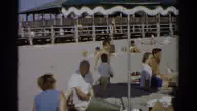 Catskill New York (1957): Three People Wade In Sea Surf While Others Sit Under