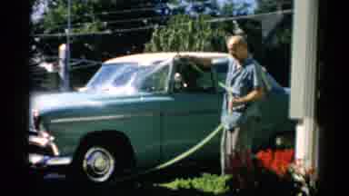 Catskill New York (1957): Older Man Washing His Car With A Hose On A Sunny Day