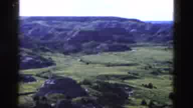 Yellowstone Wyoming USA (1958): View Of Green Fields And Mountains On A Sunny Day