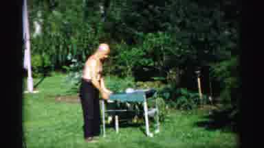 Catskill New York (1957): Older Man Shirtless Setting Up Small Outdoor Grill