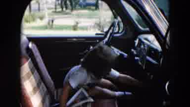 Hicksville New York (1957): Girl Wearing White Dress Shakes Silver Object On A
