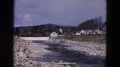Hicksville New York (1957): Stream Flows In Rocky Riverbed Between Buildings And