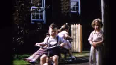 Hicksville New York (1957): Children Play With Tricycles On A Bright Sunny Day