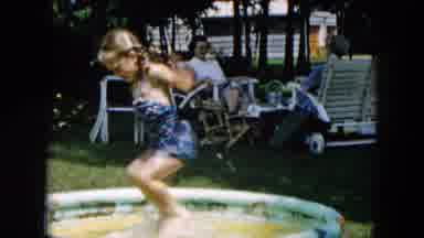Hicksville New York-1957: Little Girl Splashes In Small Pool As Grandpa And Grandma Watch