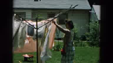 Hicksville New York (1957): Child Reading Book And Mum Hanging Clothes