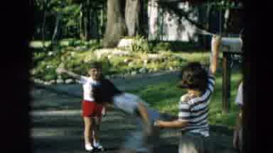 Hicksville New York (1957): Children Play Jump Rope In Street On A Bright Sunny