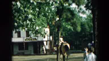 Hicksville New York (1957): Man Mounts A Horse In A Populated Area Near A General