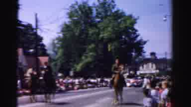 Normal Illinois USA (1957): Men On Horses Walking In A Parade With A Red Car