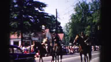 Normal Illinois USA (1957): Three People On Horseback In A Street During A Parade