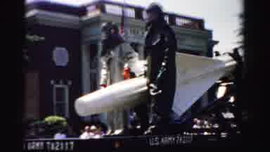 Normal Illinois USA (1957): Black Truck Pulls Rocket Parade Float On A Bright