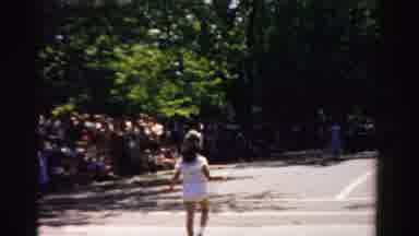 Normal Illinois USA (1957): Girl Marches Down Street Twirling And Tossing Baton In