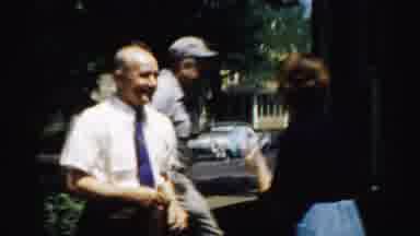 NORMAL ILLINOIS USA-1957: Two Men And A Woman Nudge Each Other Then Point To The