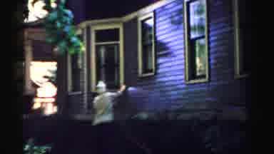 Normal Illinois USA (1957): Older Woman Using A Garden Hose To Clean The Siding Of