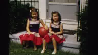 Normal Illinois USA (1957): Two Matching Girls Playing Ball In The Front Yard Of A
