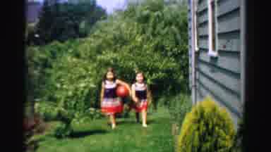 Normal Illinois USA (1957): Twin Girls Wearing Red White And Blue Dresses Toss Red