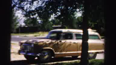 Normal Illinois USA (1957): Gold Colored Station Wagon Backing Up Driving Reverse