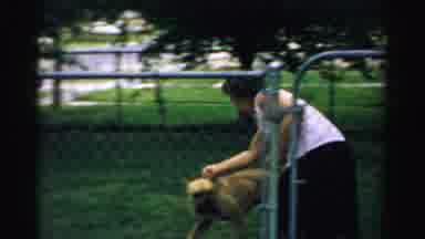 Normal Illinois USA (1957): A Clip Of A Woman Putting Her Dog On A Leash In Her