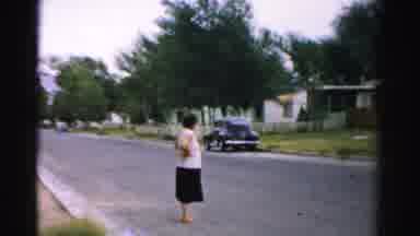 Normal Illinois USA (1957): Lady Standing In The Middle Of A Street And A Old