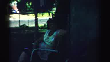 Normal Illinois USA (1957): People Sitting In Chairs In The Shade On A Sunny Day