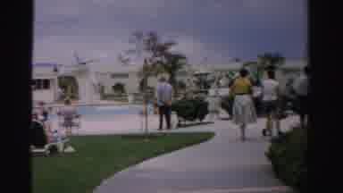 Las Vegas Nevada (1957): People Walking Past Blue Swimming Pool On A Clear Sunny