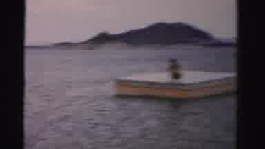 NEVADA USA-1957: Woman Sits On A Floating Dock In The Middle Of The Water On A