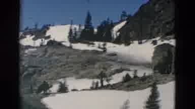 OREGON USA-: Snowy Mountain Views Panning Two Cars Descending Down The Road