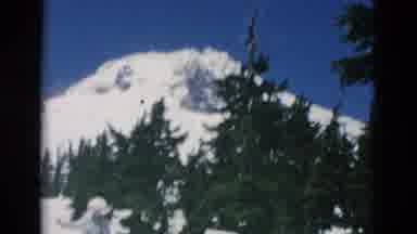 OREGON USA-: People Walking Up A Steep Snow Covered Slope At The Foot Of A