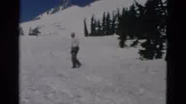 OREGON USA-: Man Wearing Grey Pants Stands In Snow With Binoculars On A Sunny