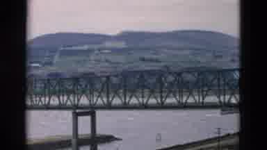 OREGON USA-: Automobiles Crossing Iron Bridge Over Water Low Mountains In