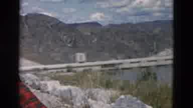 Montana USA (1958): A Man In A Red And Black Flannel Coat Stands Next To A Dam