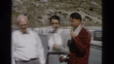 Montana USA (1958): Three People Are Viewing A Large Dam On The Water