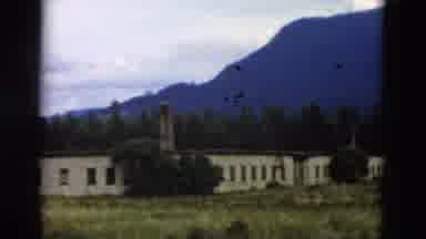 Yellowstone Wyoming USA (1958): Building In The Distance With Mountains In The