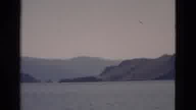 YELLOWSTONE WYOMING USA-1958: Camera Pans Across Lake With Mountain Views